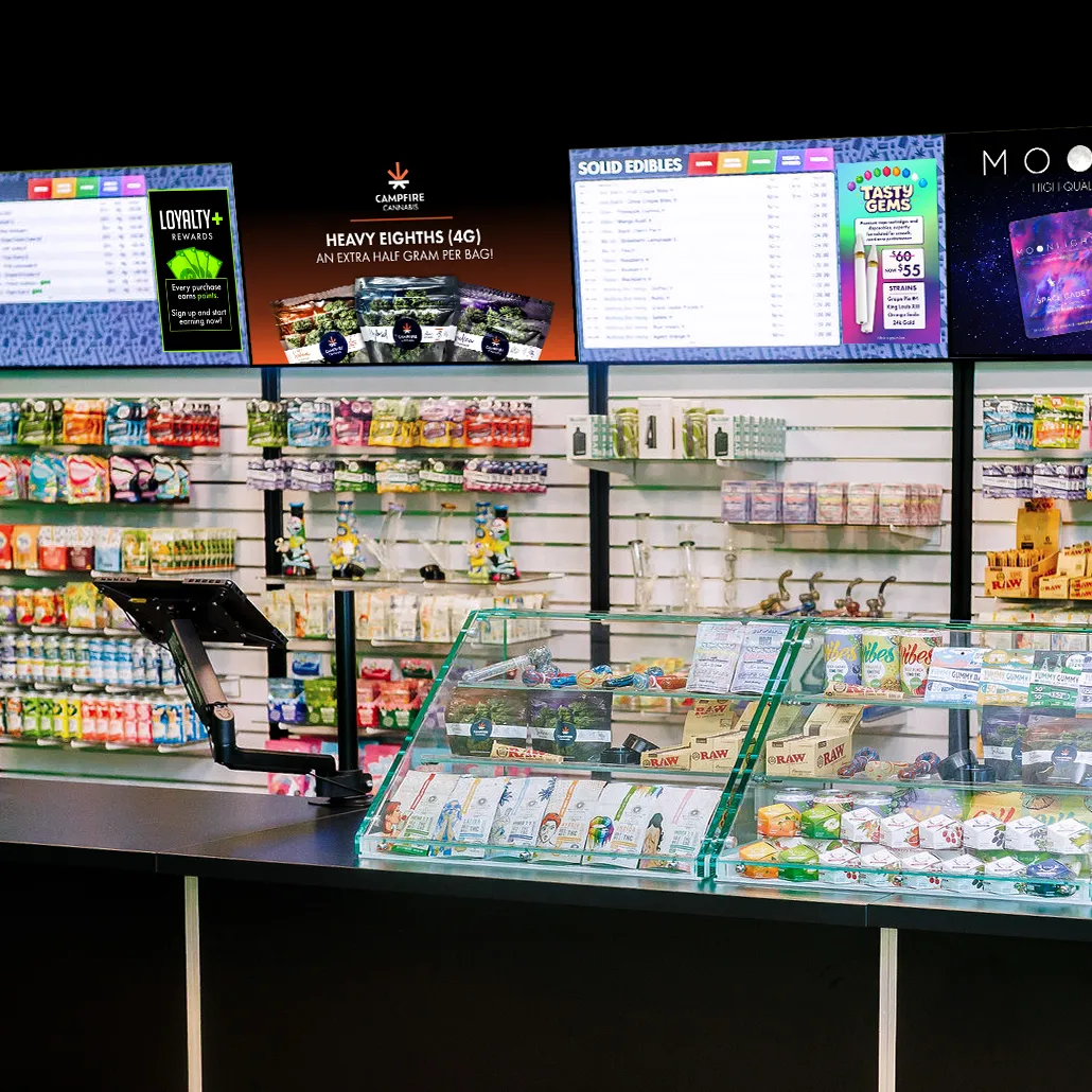 Inside St Louis Park Canna — the retail counter, display case, and menu screens